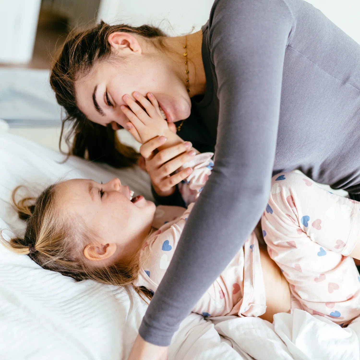 Family resting together on a protected bed